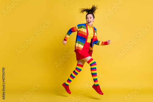 Full length body size view of pretty glad cheerful wavy-haired girl jumping running isolated bright yellow color background