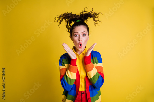 Photo of astonished girl information scream blow hair wear rainbow clothes isolated shine color background