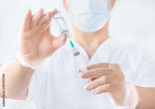 Doctor s hands with syringe and ampoule  injection