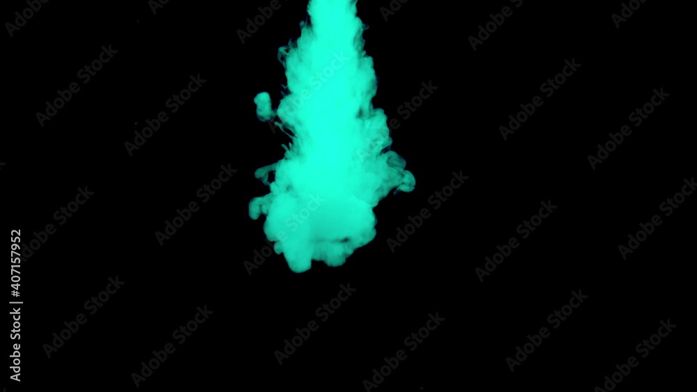 Real shot green paint drops in water. Ink swirling underwater. Cloud of ink collision isolated on black background. Close up view
