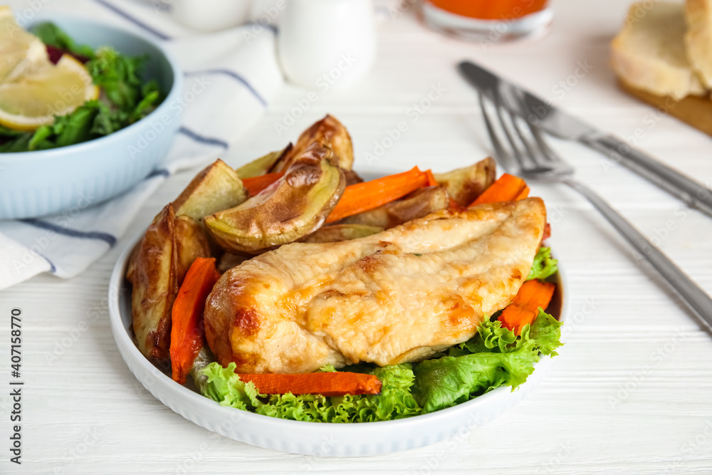 Delicious cooked chicken and vegetables on white wooden table, closeup. Healthy meals from air fryer
