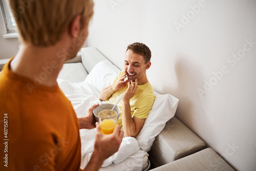 Loving man bringing delicious breakfast to his boyfriend