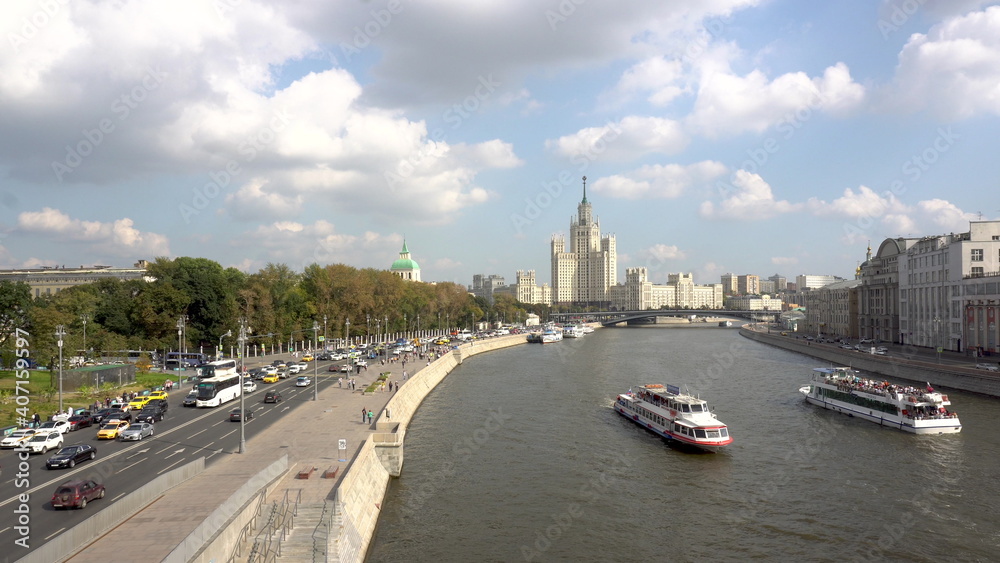 Fototapeta premium The old Stalinist skyscraper stands in the distance. View of the highway and the Moscow river