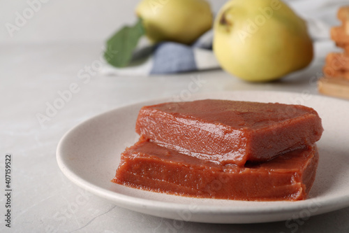 Delicious quince paste on white table, closeup