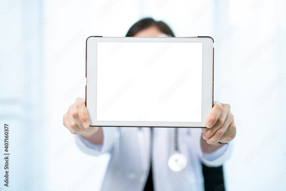 Unrecognizable specialist doctor holding an empty blank screen tablet isolated in white close up.