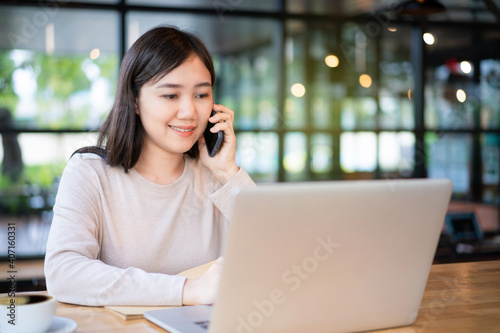 Free Download Asian woman working at co-working space in the cafe or coffee shop. - GFXLoad