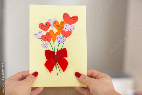Woman holding a handmade, creative valentines orbirthday card. photo
