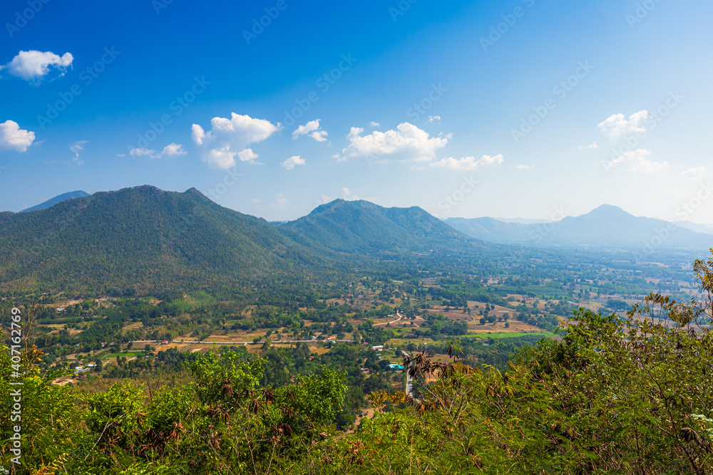 Beautiful panoramic view green forest mountain range Phu Thok Park in Loei province,Thailand, blue sky background texture with white clouds