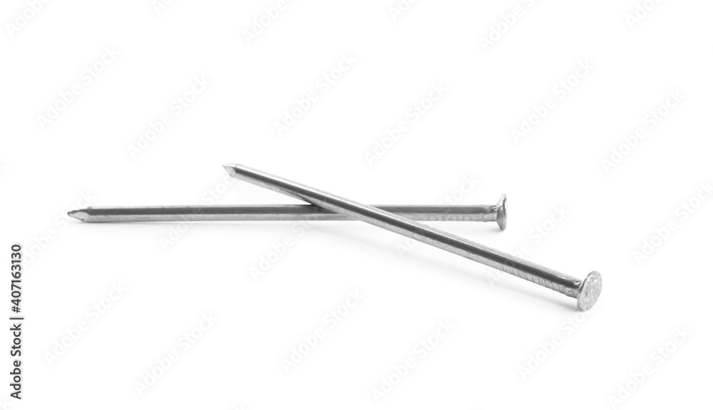 Sharp shiny metal nails on white background Sharp shiny metal nails on white background