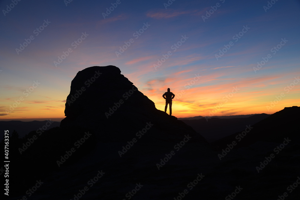 Contemplating sunrise in mountains-