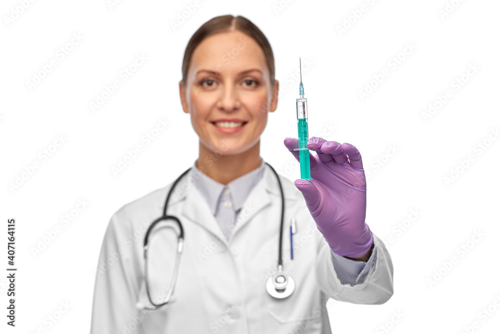 medicine, vaccination and healthcare concept - close up of happy smiling female doctor with stethoscope and syringe over white background medicine, vaccination and healthcare concept - close up of happy smiling female doctor with stethoscope and syringe over white background