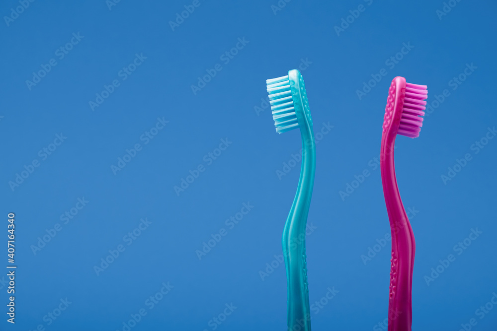 Pink and blue toothbrush with distance between like couple in fight Pink and blue toothbrush with distance between like couple in fight