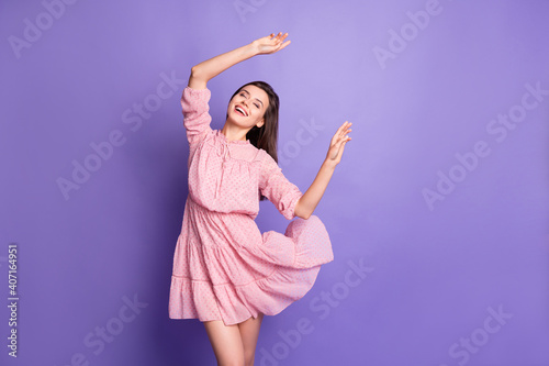 Portrait of pretty elegant chic dreamy cheerful girl dancing having fun isolated over bright violet color background