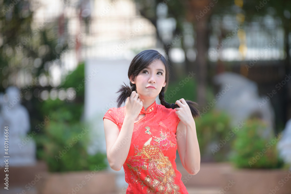 Action portrait beautiful Asian girl wearing Cheongsam green dress. the celebration of something in a joyful and exuberant way. Festivities and Celebration concept Action portrait beautiful Asian girl wearing Cheongsam green dress. the celebration of something in a joyful and exuberant way. Festivities and Celebration concept
