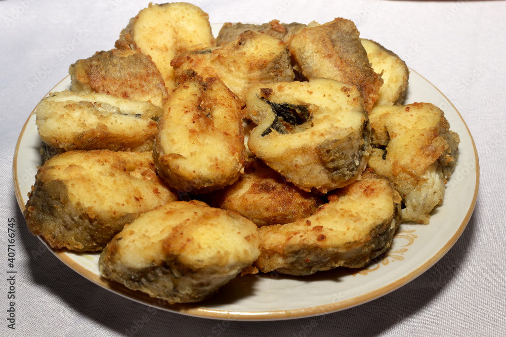 Pieces of fried fish on a plate close-up