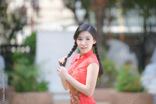 Action portrait beautiful Asian girl wearing Cheongsam green dress. the celebration of something in a joyful and exuberant way. Festivities and Celebration concept
