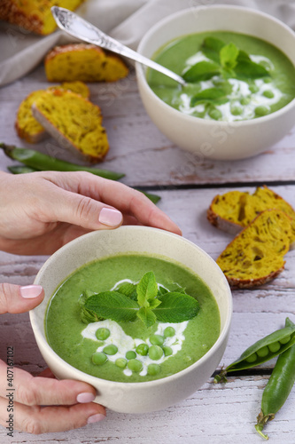  Chilled soup puree of green peas, seasoned with green onion, mint and crunchy toasted diced rusk bread 