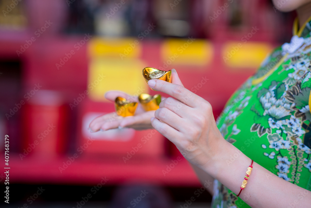 Close up hand sending and receiving red envelope Symbols of the Chinese New Year on golden bokeh background. gifts, festivals and celebration concept Close up hand sending and receiving red envelope Symbols of the Chinese New Year on golden bokeh background. gifts, festivals and celebration concept