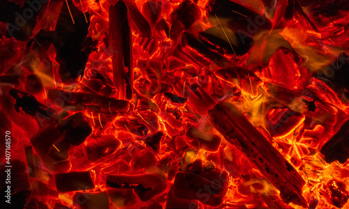 Burning firewood, glowing coals, fire and flames closeup photo. Burning coal for a barbecue photo