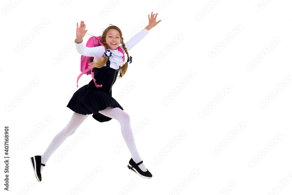 Smiling schoolgirl happily jumping high Smiling schoolgirl happily jumping high