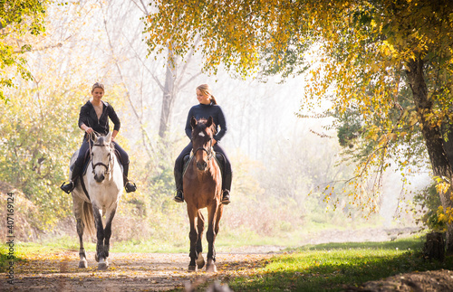 Two girls ride beautiful horses