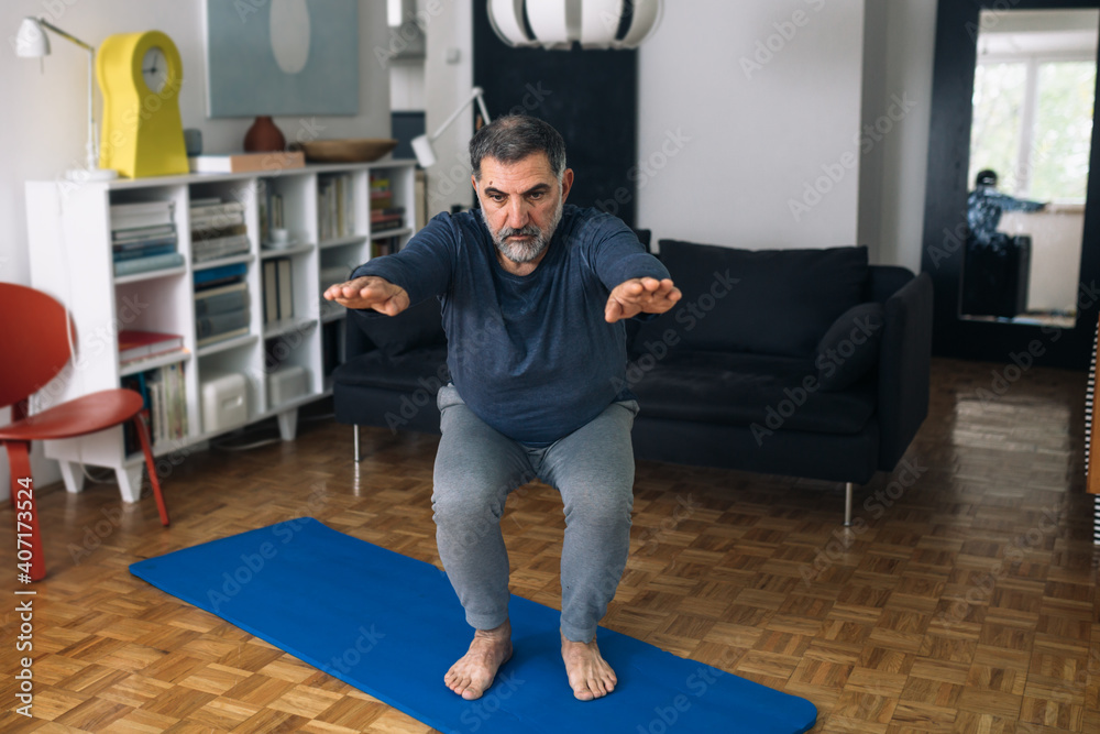 middle aged man exercise in his home