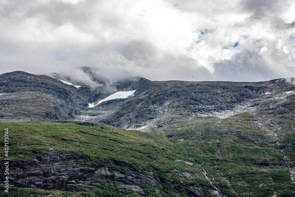 Clouds are hanging at huge mountains in Norway