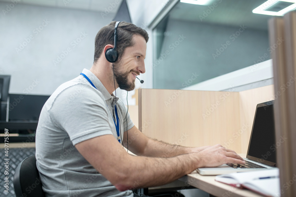 Man in headphones working at laptop Man in headphones working at laptop