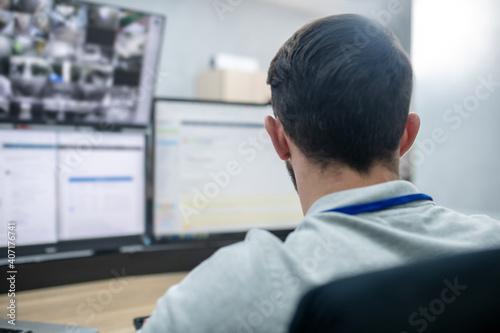 Фотография Man with his back to camera working at computer