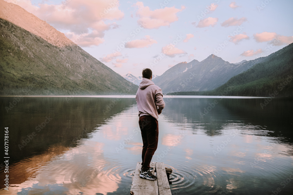 Pier on a mountain lake. beautiful sunset reflected in the water Pier on a mountain lake. beautiful sunset reflected in the water