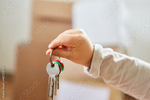 Toddler holds bunch of keys with lots of keys