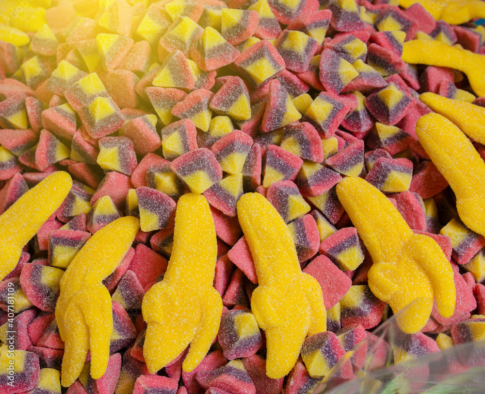 Yellow jelly banana candies close up as a bright joyful background