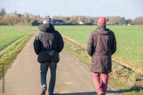 Obraz na płótnie 2 hommes marchent sur une route de campagne w salonie