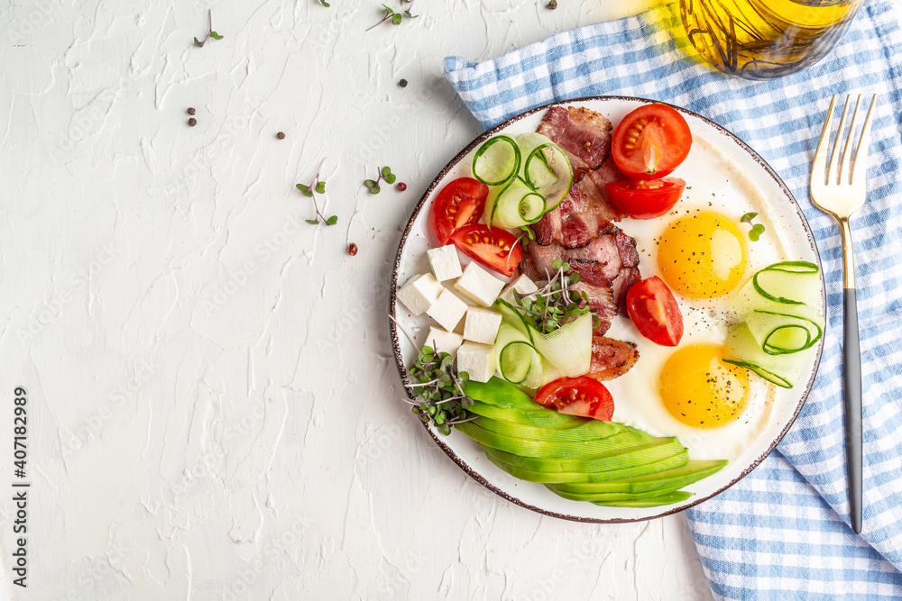 Keto breakfast with eggs, avocado, tomatoes, bacon and cheese. Ketogenic paleo diet. banner, catering menu recipe place for text, top view