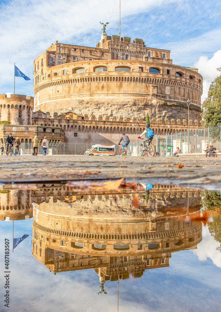 Rome, Italy - in Winter time, frequent rain showers create pools in which the wonderful Old Town of Rome reflect like in a mirror. Here in particular Castel Sant'Angelo