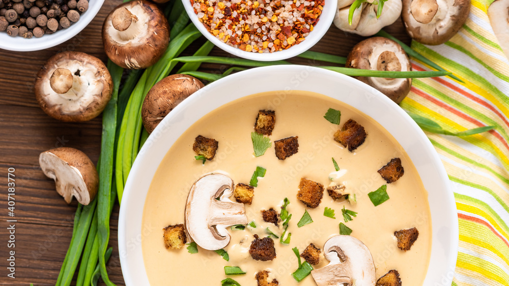 Mushroom cream soup on a wooden background with sliced mushrooms and onions. Mushroom cream soup on a wooden background with sliced mushrooms and onions.