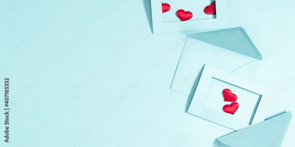 Creative minimal Valentine's Day concept. Envelopes, red hearts confetti, valentines on pastel blue background. Flat lay, top view, copy space Creative minimal Valentine's Day concept. Envelopes, red hearts confetti, valentines on pastel blue background. Flat lay, top view, copy space