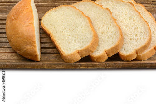 Slices of sliced bread lie in a wooden bread box.Isolated white background. Top view with copy space.