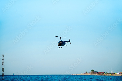 Fototapeta Naklejka Na Ścianę i Meble -  Helicopter is flying low over the sea