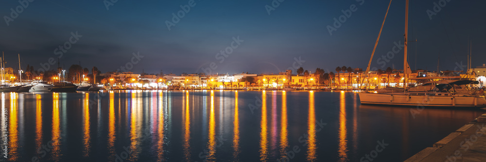 The capital of the island of Kos, Greece, view of the city and marina at night, banner panoramic view