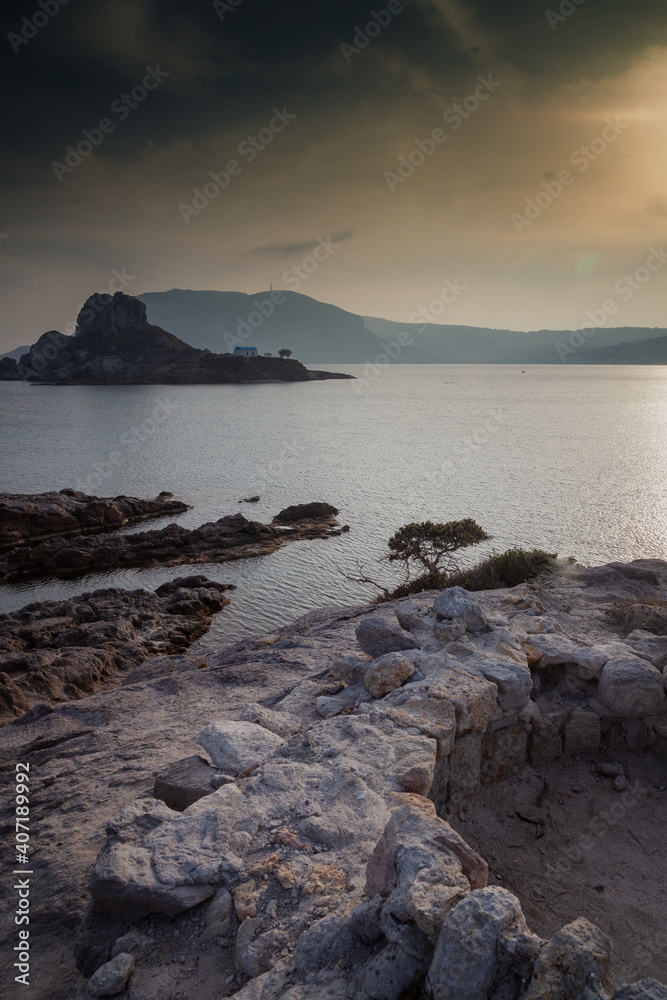Kos island, Greece, coast view of Kefalos village, island of Kastri and an orthodox temple at sunset