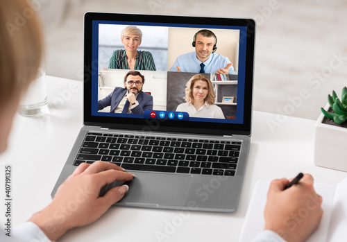 Lady Talking With Colleagues Online Via Video Call Sitting Indoors