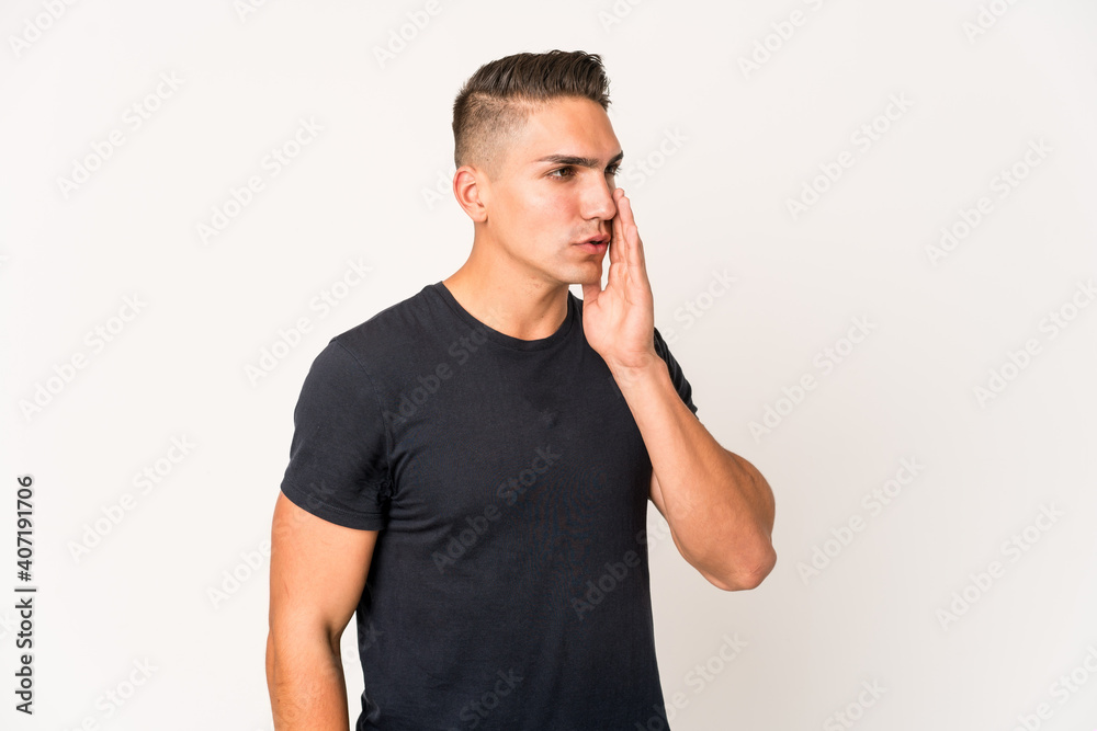 Young caucasian handsome man isolated is saying a secret hot braking news and looking aside Young caucasian handsome man isolated is saying a secret hot braking news and looking aside