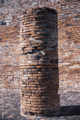 Ancient stone pillars made of red bricks.