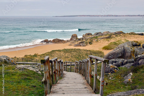 Coastal landscape from the top of the wooden stairs at O Vilar beach. Galicia Spain. This place is located within the Corrubedo Dunes Natural Park photo