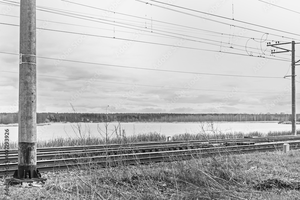 Fototapeta premium Real railway along river at cloudy day