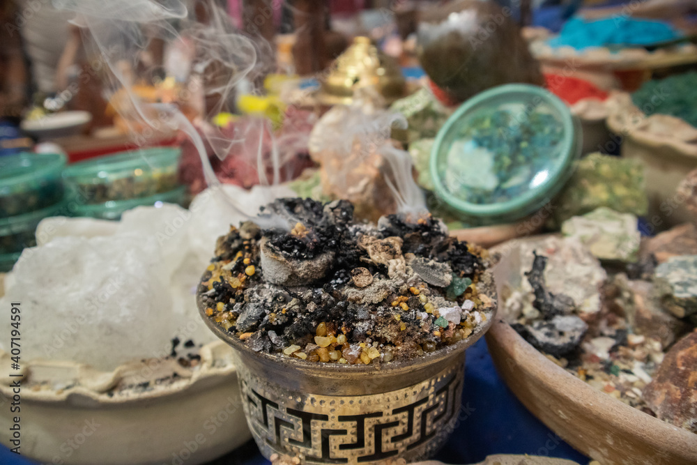 smoke comes from burning incense and around the table of different