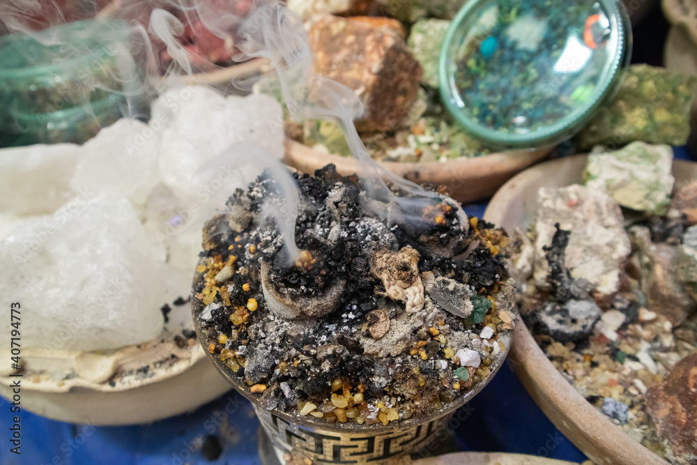 smoke comes from burning incense and around the table of different