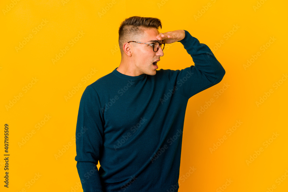Young handsome caucasian man isolated looking far away keeping hand on forehead. Young handsome caucasian man isolated looking far away keeping hand on forehead.