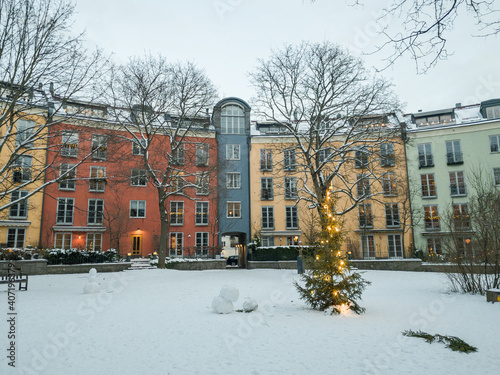 Photography Colorful building with the snowy garden and christmas decoration with lonely sno